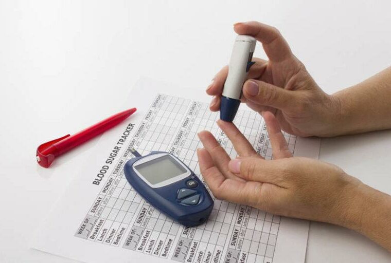 woman's hands and glucometer